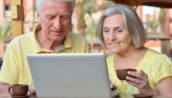 deux personnes âgées en regardent un ordinateur