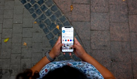 femme visitant le profile Instagram de la Ville via smartphone. 