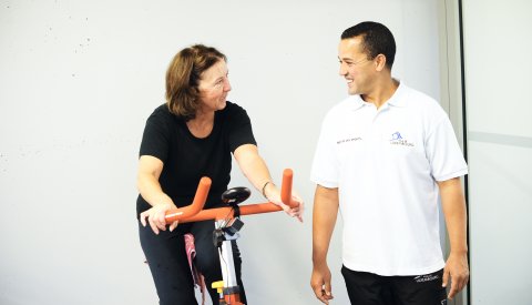 Un instructeur du sport dirige un vieille femme